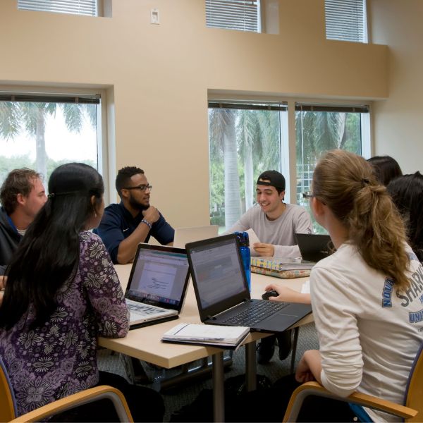 students gathered around a table studying