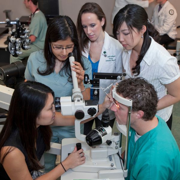optometry students learning how to use equipment