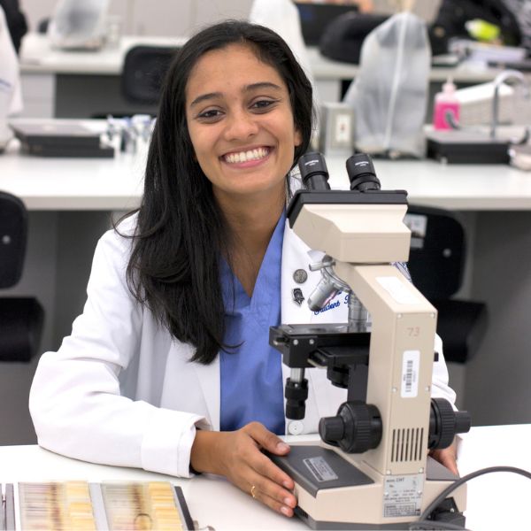 osteopathic student working with a microscope