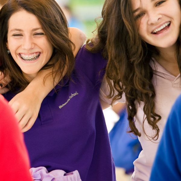 two female university school students laughing
