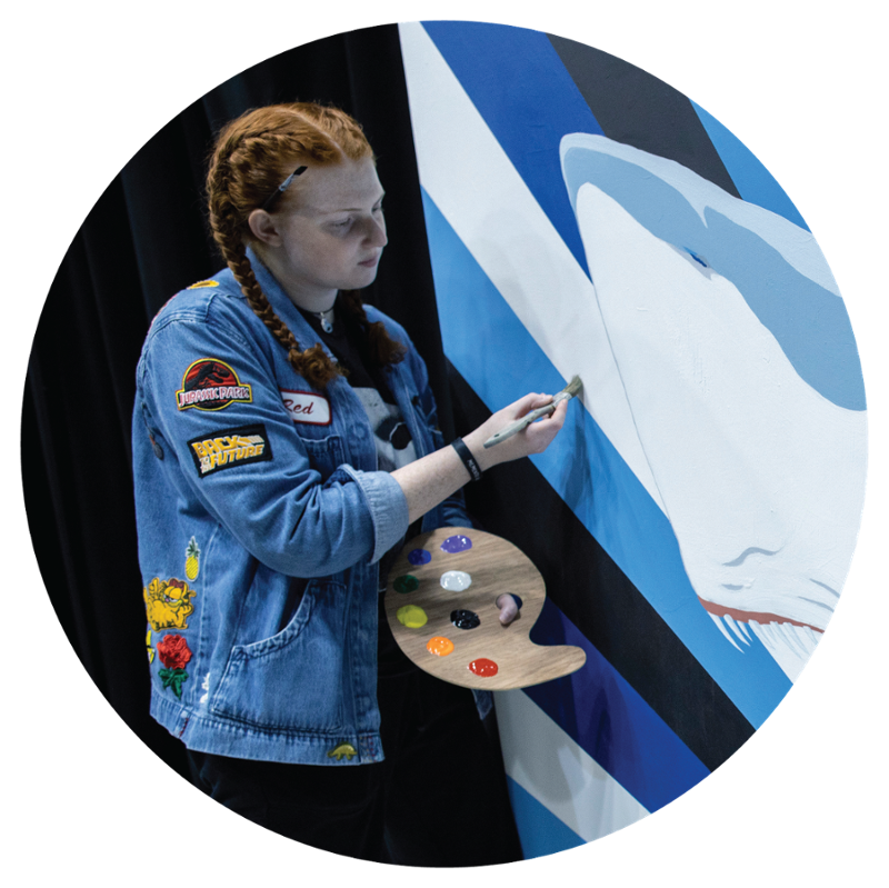 A girl painting an NSU Shark painting