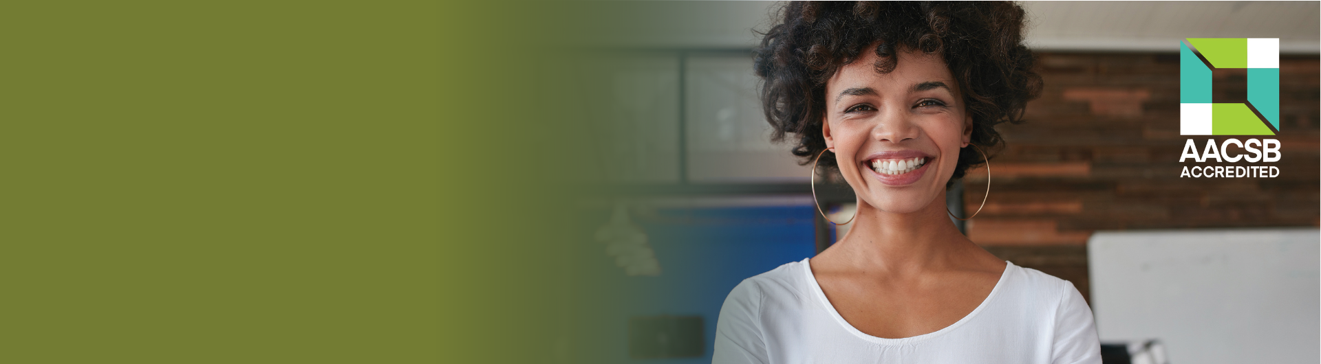 smiling business woman with AACSB logo in background