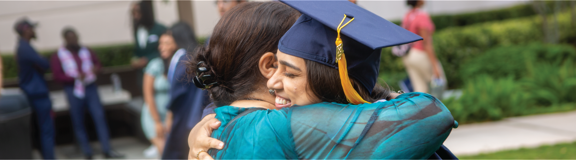 A happy NSU graduate is hugging her mother smiling