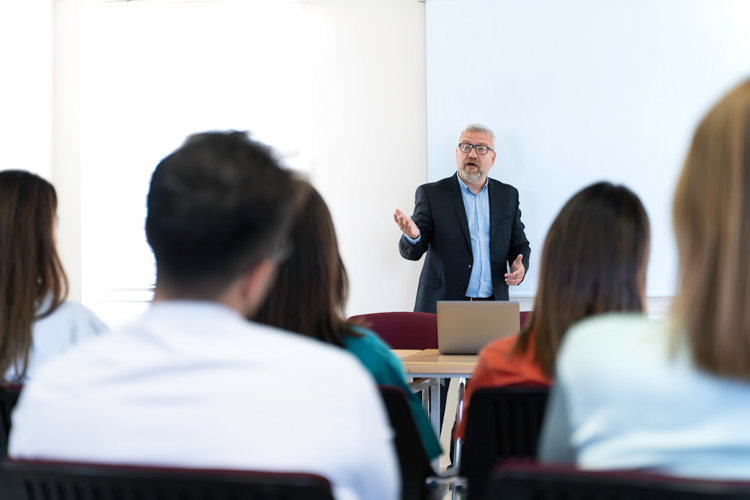 Faculty giving lecture to class