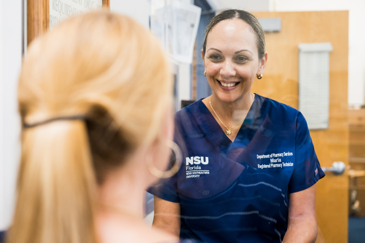 Student success working as a pharmacist attending a patient