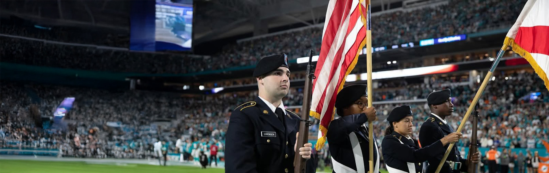 NSU army ROTC Amber Hockaday at stadium event holding flag
