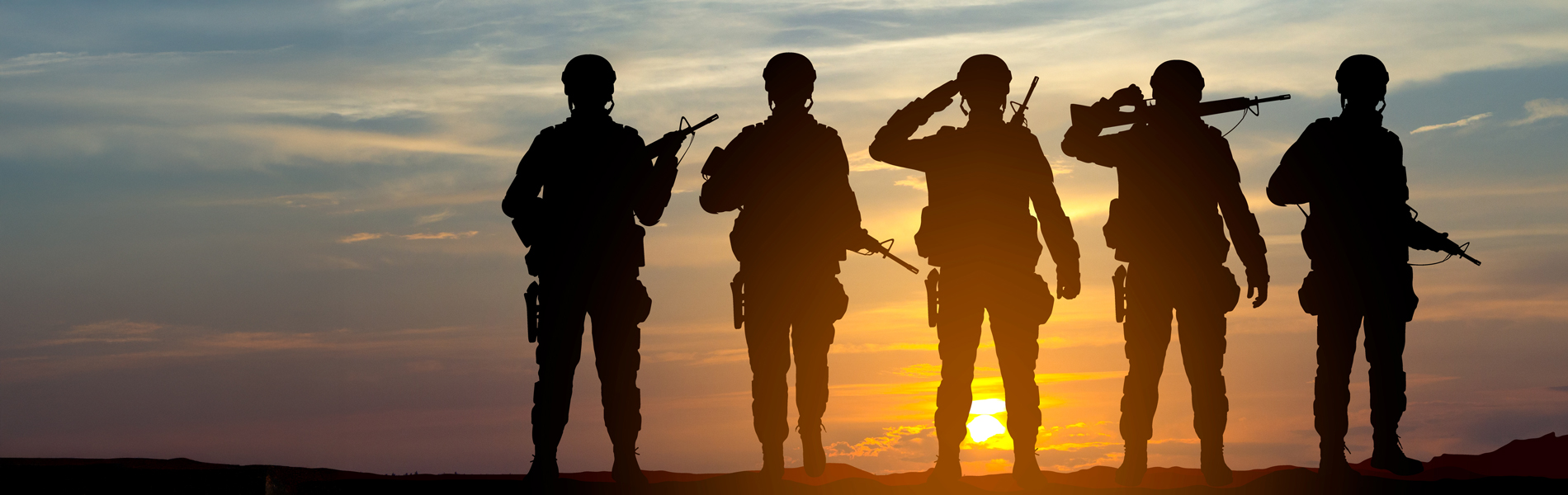 Silhouettes of soldiers against the sunset
