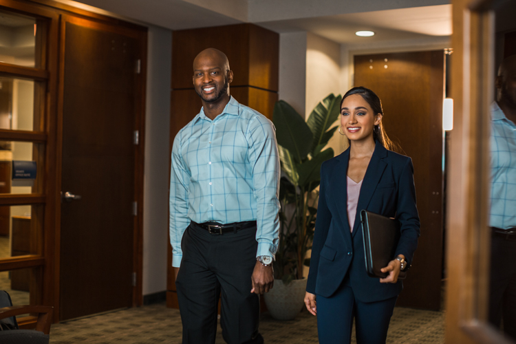 Business students walking around campus offices 