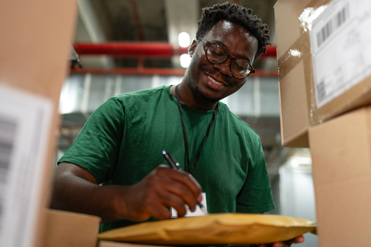 Postal person signing documents for delivery