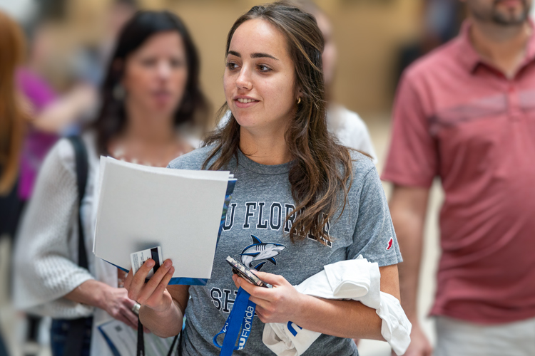 Student holding enrollment documents