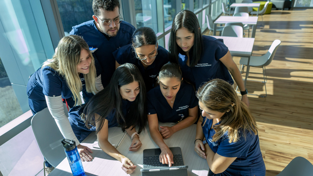A group of nsu students looking at computer screen