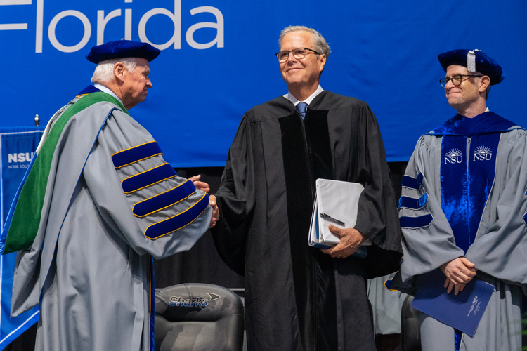 Faculty on stage at commencement ceremony