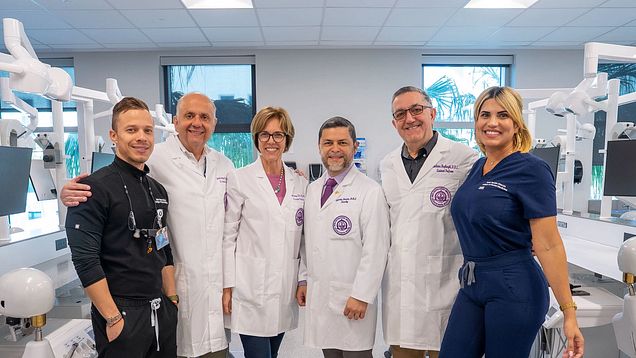 Group of faculty and students in dental simulation lab.