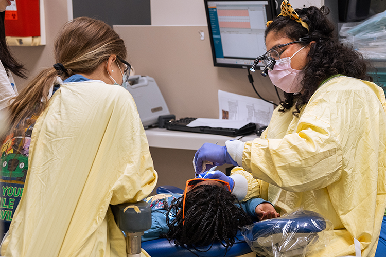 Dentists doing a teeth cleaning process