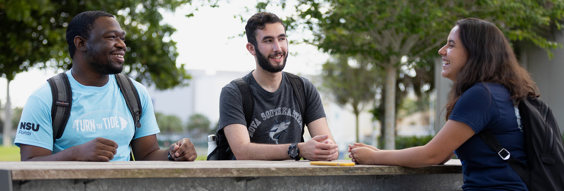 NSU students sitting outside and talking