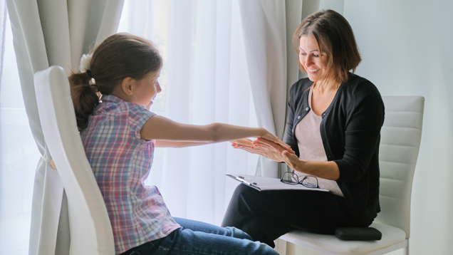 Child psychology social worker talking to girl