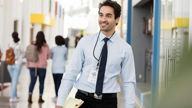 Education leader walking in school hallway