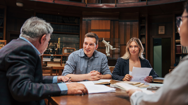 PHD criminal justice team speaking on desk