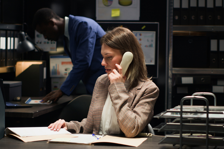 Criminal justice working on papers and speaking in the phone