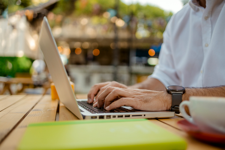 Man applying for degree in laptop electronically