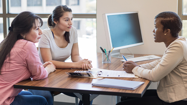 Mother and daughter speaking to their advisor