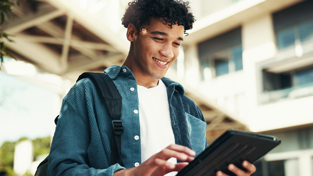 Student using a digital tablet outdoors