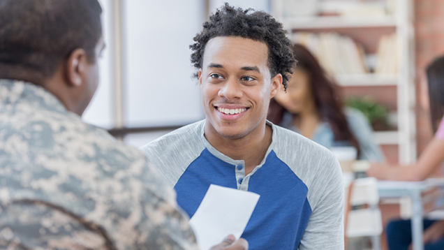 Veteran speaking to a student