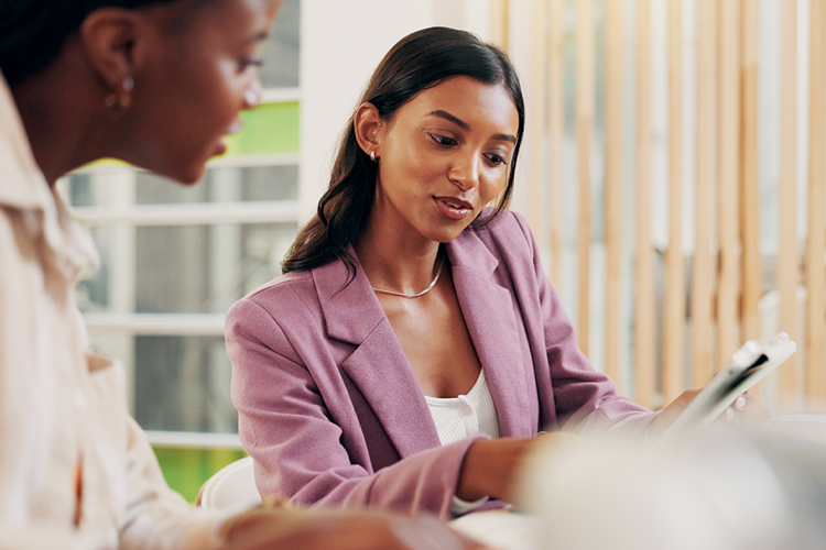 Two women looking at a document