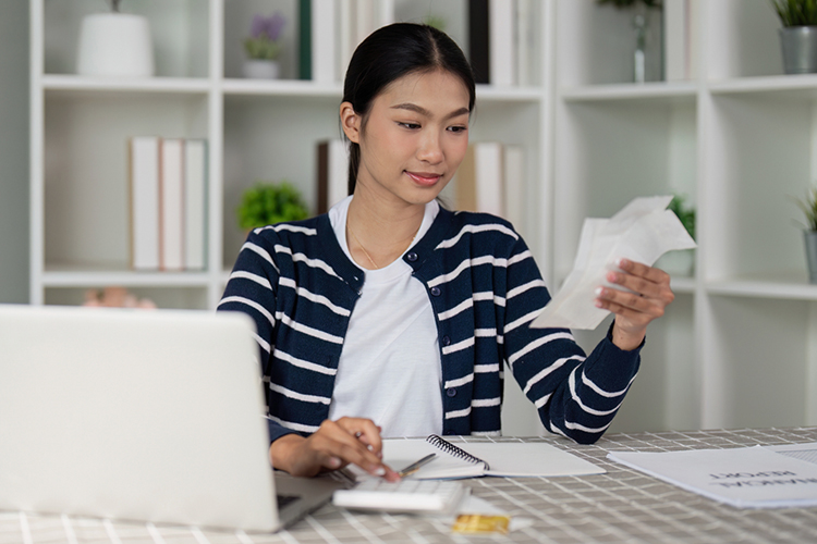 Woman managing her finances on a laptop