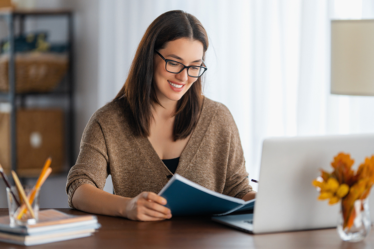 Woman sitting at her desk reading a document