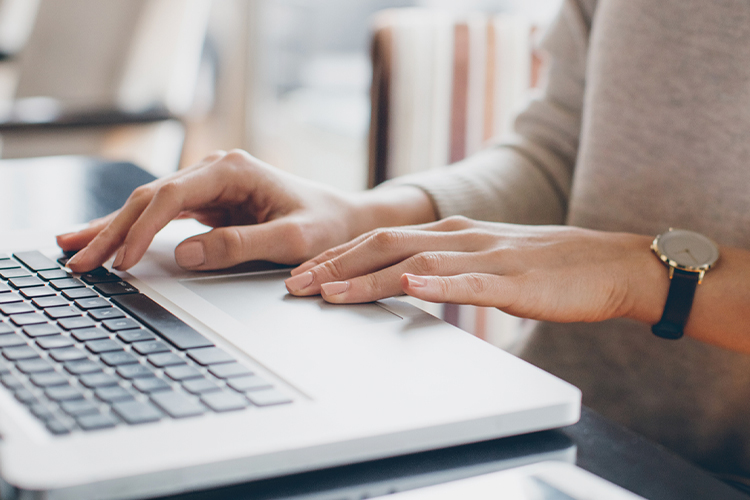 Woman typing on laptop