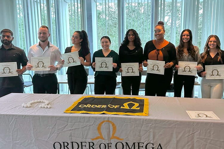 Order of omega members holding their certificates