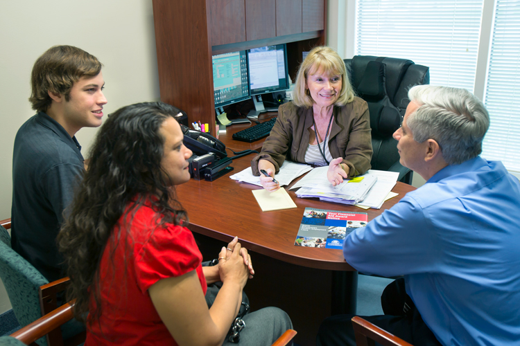 Students applying for financial aid on the office