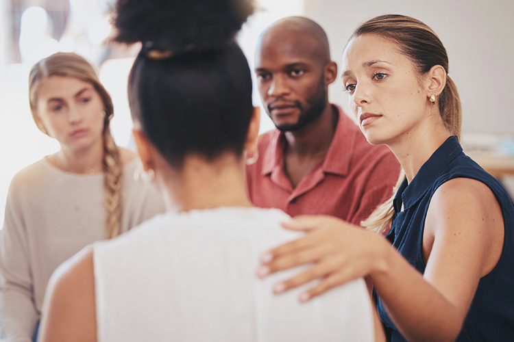 Support group listening to a woman speak