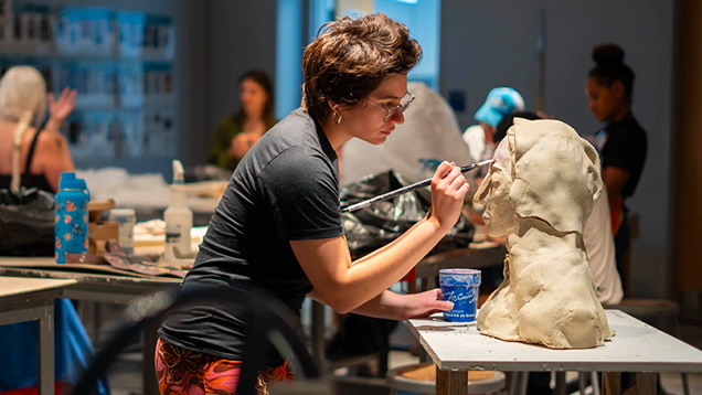 Art student working on clay sculpture