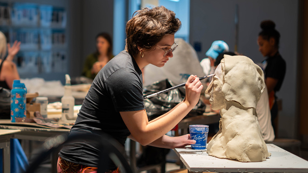 Art student working on sculpture