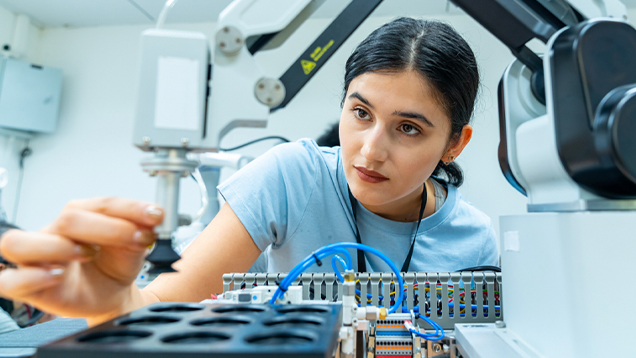 Engineer working on a robotic machine arm