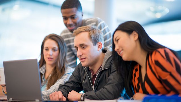 group of students looking att computer