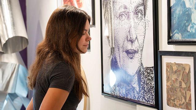 Student looking at art in a gallery