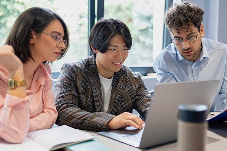 Group of students using a laptop