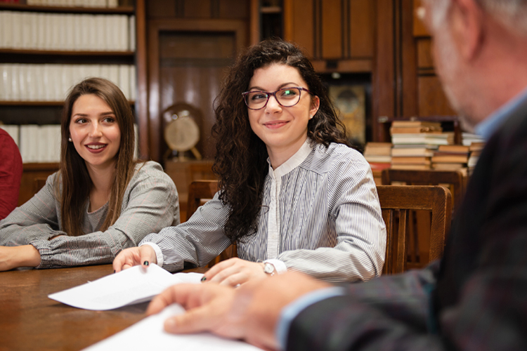 Students listening to their teacher in a library