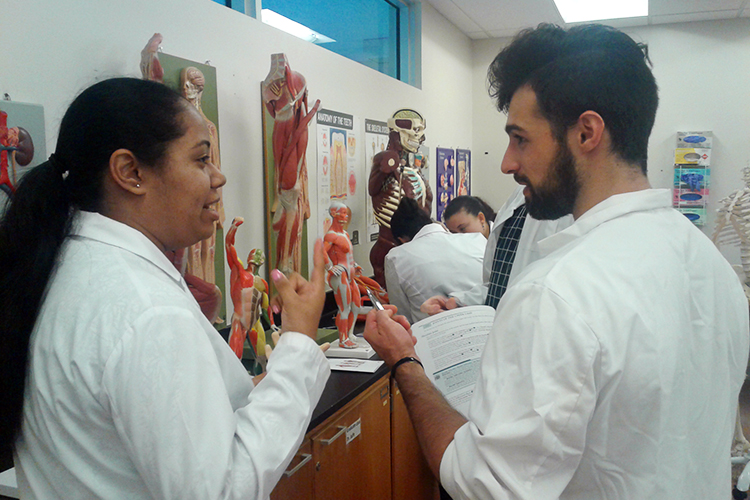 Students and professor speaking in lab
