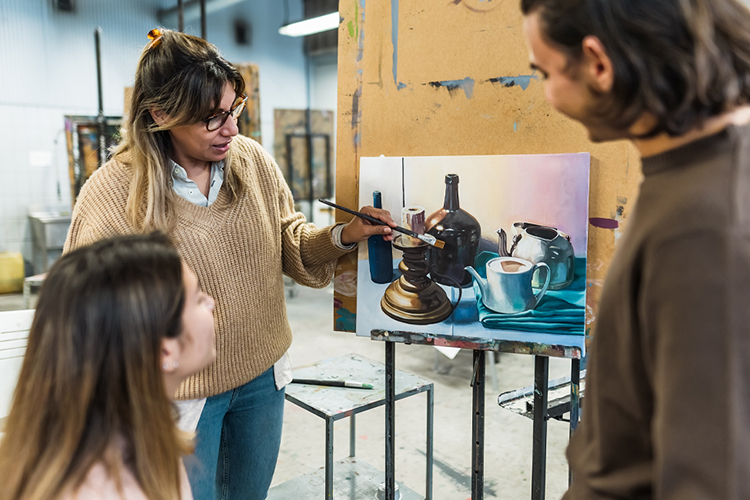 Teacher and students in a painting class