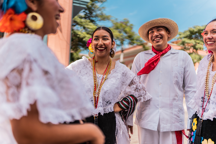 Traditional Mexican dancers talking outdoors