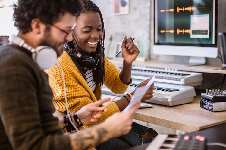 Two people recording music in a studio