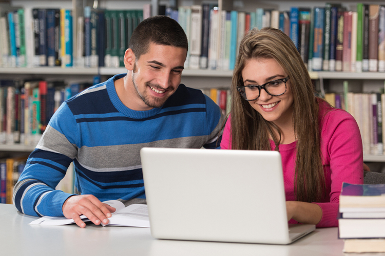 Two students using a laptop