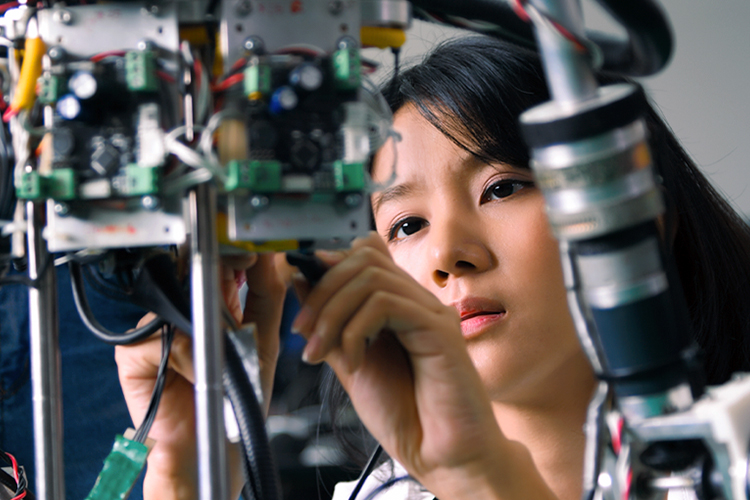 Woman building a machine close up