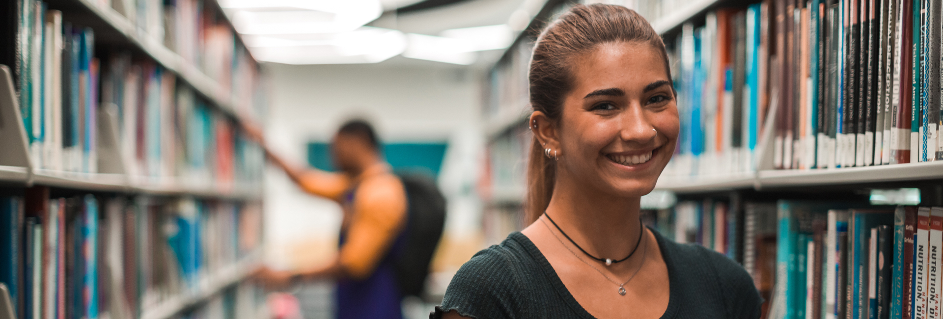 Student smiling in library