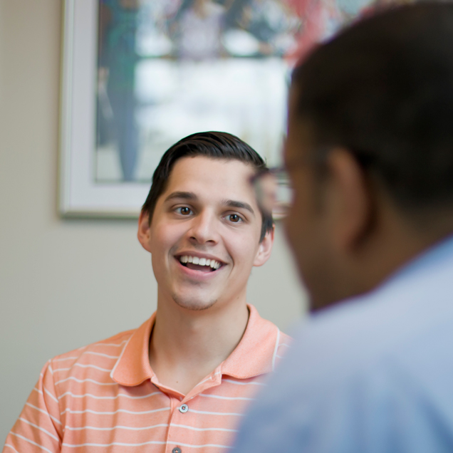 Alumnus talking to a student