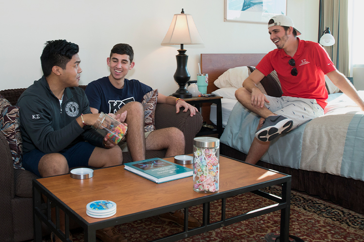 Group of NSU students talking in their room